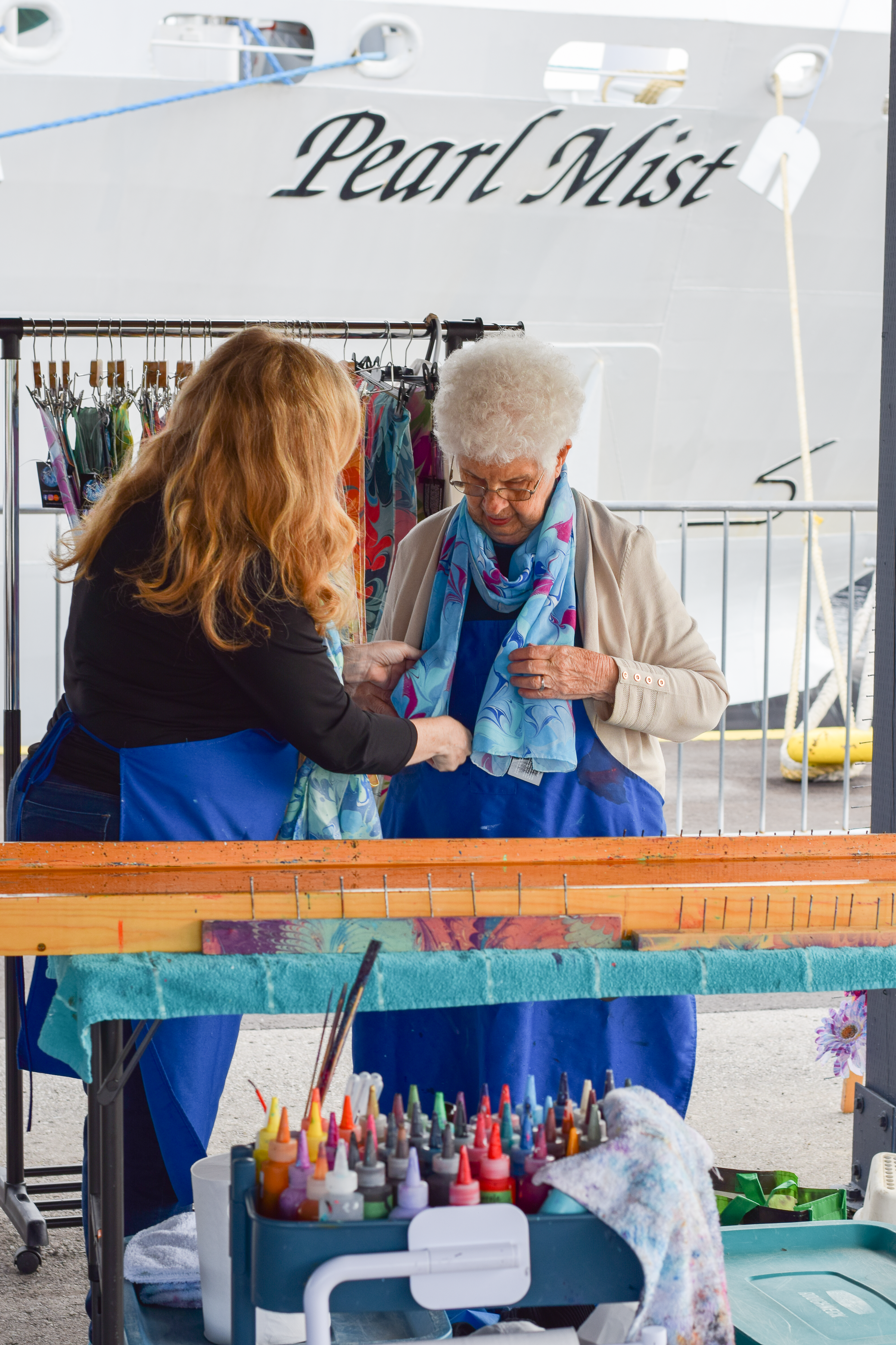 vendor helping customer with scarf